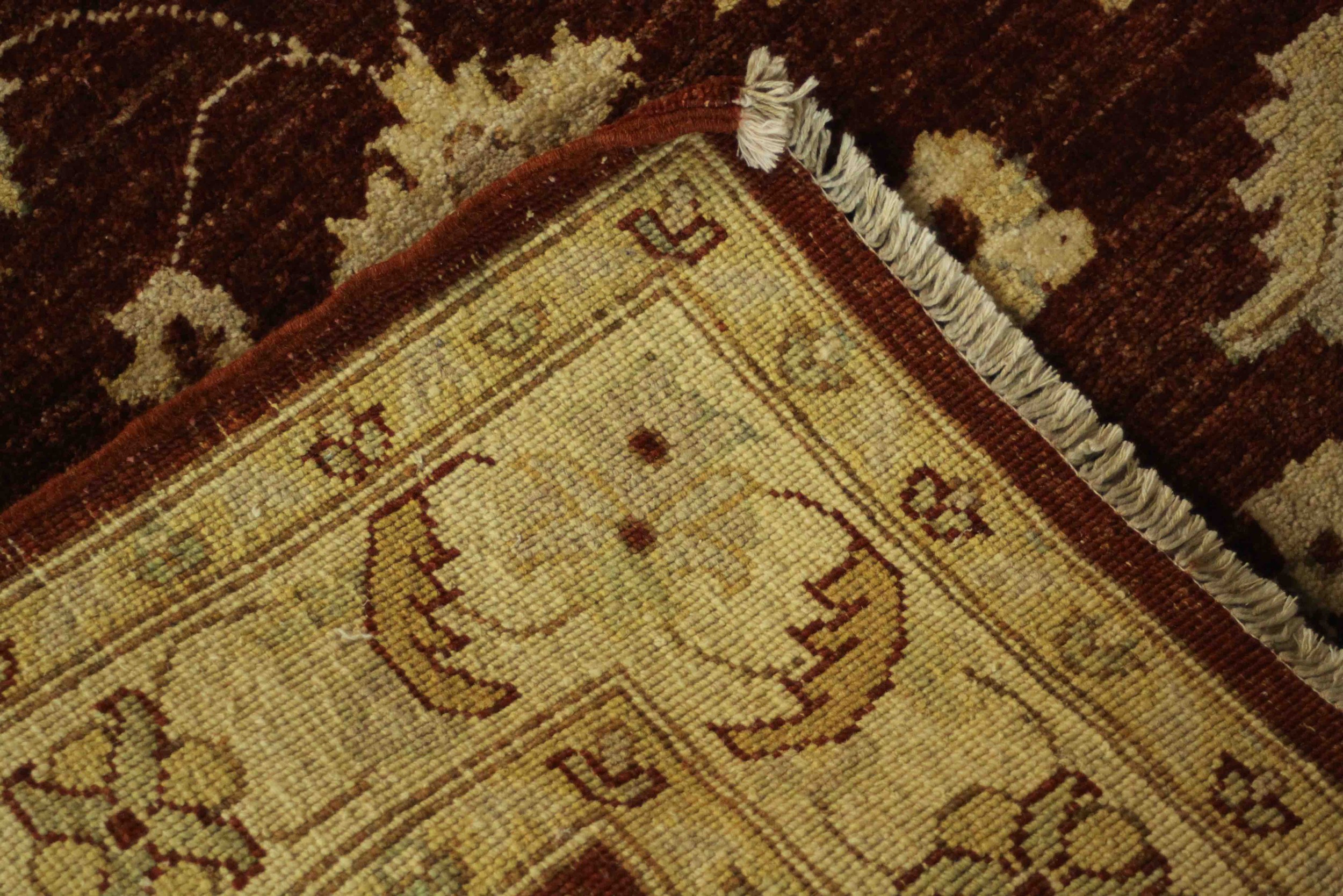 A Ziegler style rug with repeating foliate motifs on a burgundy field within serrated palm - Image 5 of 5