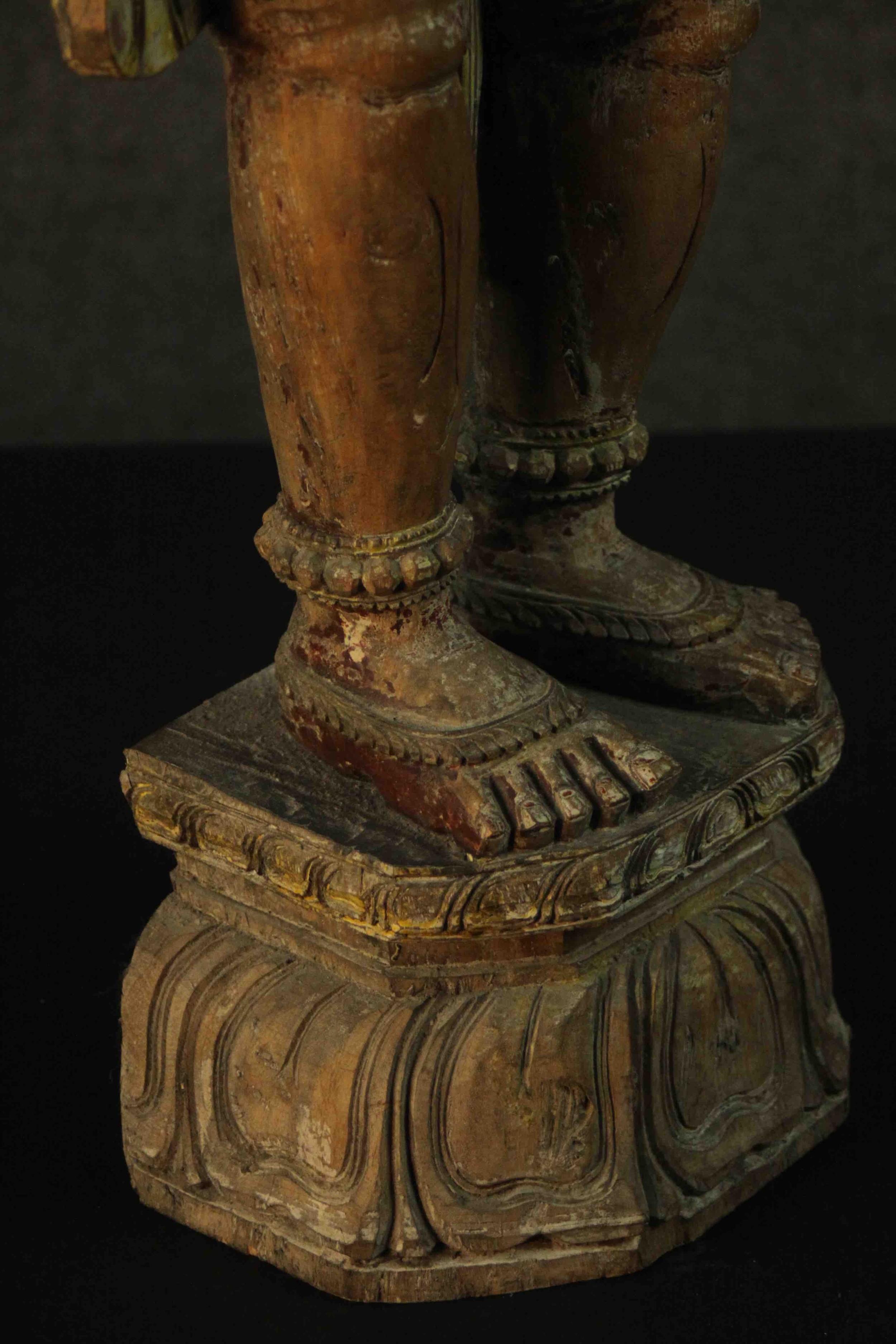 A large carved and painted 19th century Oriental statue of a deity standing on a lotus form base. - Image 9 of 10