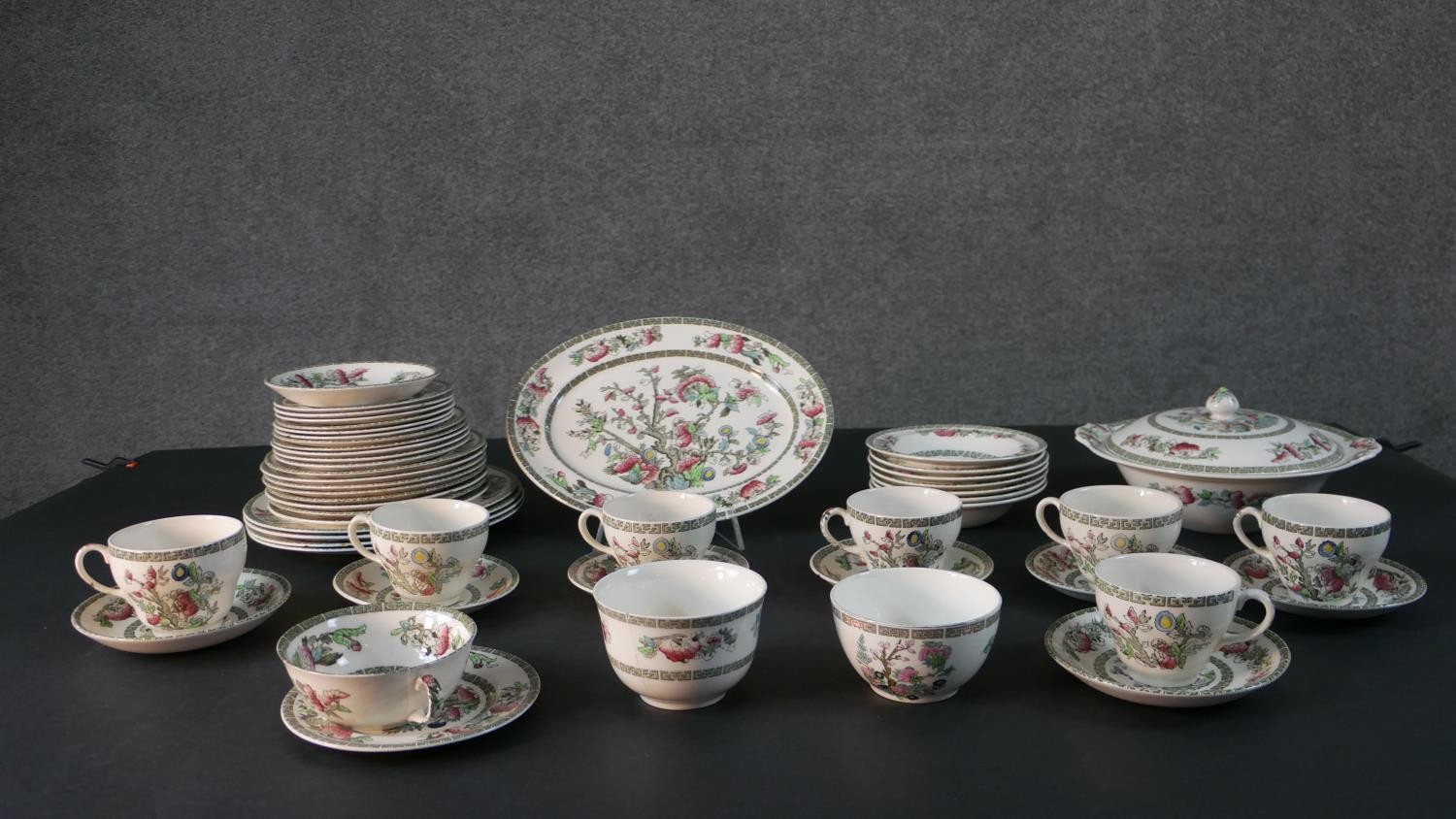 A Johnson Brothers Indian Tree pattern eight person part dinner service. Includes seven tea cups and