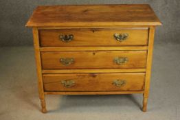 A late Victorian cedar chest of three long drawers with brass swing handles on turned feet. H.75 W.