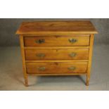 A late Victorian cedar chest of three long drawers with brass swing handles on turned feet. H.75 W.