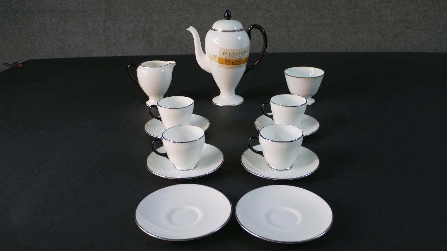 A Wedgwood six person part coffee set with black and metallic detailing, retailed from Harrods. (two