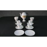 A Wedgwood six person part coffee set with black and metallic detailing, retailed from Harrods. (two