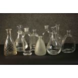 A collection of nine glass decanters, two clear crystal with blown glass stoppers. H.26 Dia.12cm. (