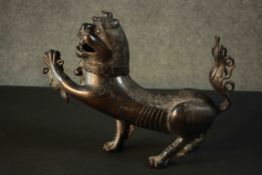 A 18th century Chinese bronze censer & cover in the form of a Buddhistic lion, the cover as the