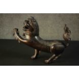 A 18th century Chinese bronze censer & cover in the form of a Buddhistic lion, the cover as the