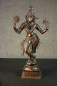 An Indian 19th century bronze figure of Krishna mounted on a hardwood base. H.72 W.36 D.21cm.