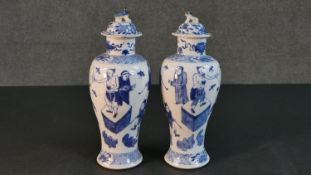 A pair of 19th century Chinese blue and white hand painted porcelain vases and covers. The lidded