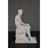 A Parian ware style ceramic figure of a seated man with woven baskets. Stamped VA to base. H.27 W.17