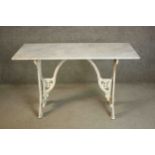 A 19th century white painted cast iron table, with a rectangular white marble top, the base with