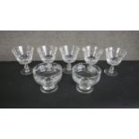 A set of five hand cut crustal sherry glasses along with two etched glass pudding glasses. H.11 W.