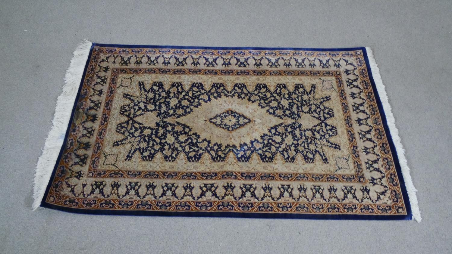 A handmade blue ground Chinese silk rug L.118 H.76cm