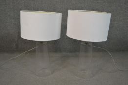 A pair of contemporary glass table lamps of slightly conical form with white shades. H.45cm