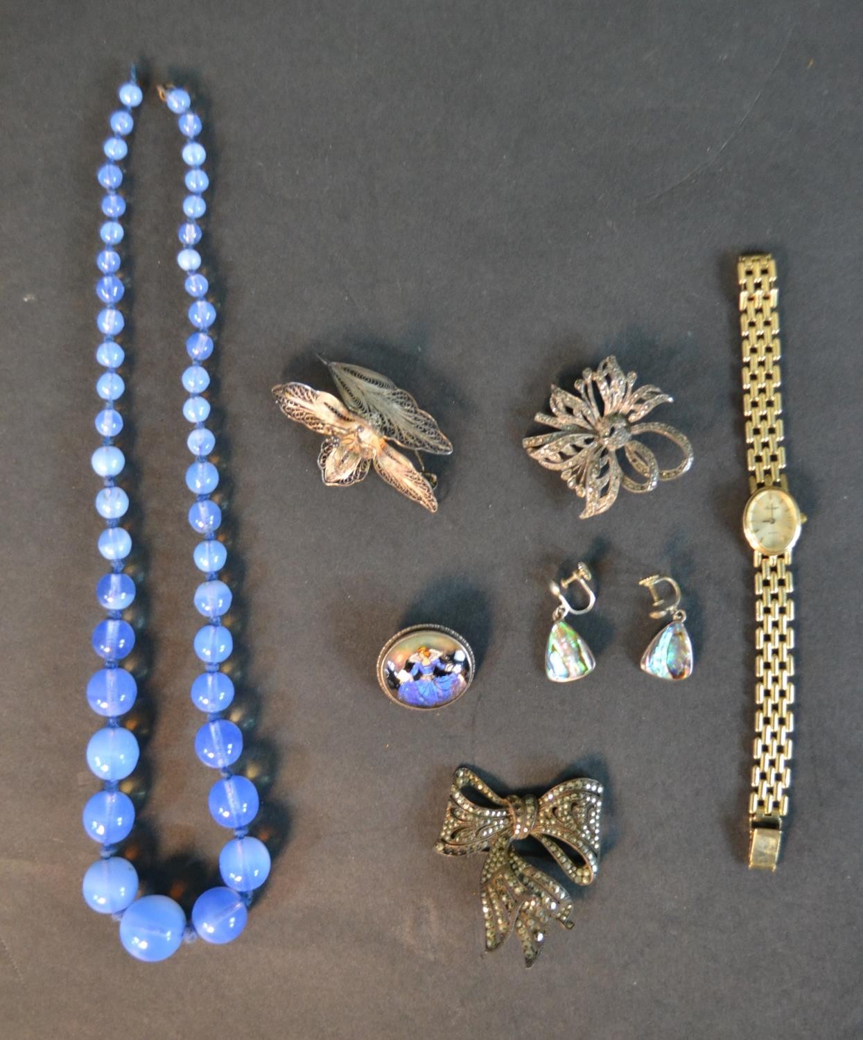 A collection of silver and costume jewellery including a blue opalescent glass necklace, a silver