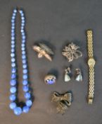 A collection of silver and costume jewellery including a blue opalescent glass necklace, a silver