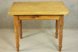 A small Victorian pine kitchen table, of rectangular form with an end drawers on turned legs. H.73