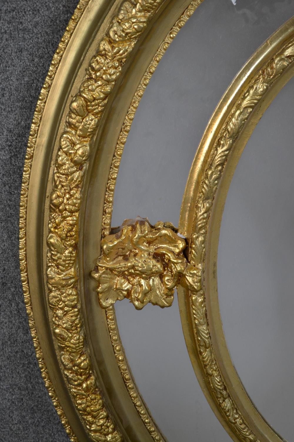 A Victorian gilt framed oval mirror, with a sectional mirror plate in an ornately moulded frame with - Image 4 of 5