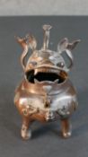 An early 20th century Chiense bronze Buddhistic lion censer, hinged head for lid. H.22 W.13 D.18cm