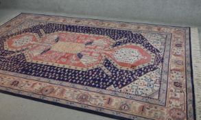 A Keshan motif carpet, the central medallion on a sapphire ground within stylised foliate borders.
