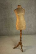 A 19th century tailors mannequin on turned tripod stand. H.152cm. (0ne leg broken).