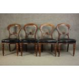 A set of four Victorian mahogany dining chairs, the serpentine fronted seats upholstered in black