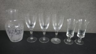 A collection of six pieces of etched glassware, including a stylised foliate design carafe, a set of