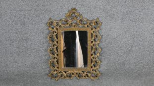 A Victorian pierced gilt metal scrolling stylised foliate design wall mirror. H.41 W.29cm