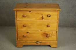 A Victorian style pine chest of three long drawers with knob handles, on bracket feet. H.76 W.80 D.