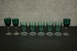 A collection of eight turquoise green glasses, including a set of five vintage clear stemmed goblets