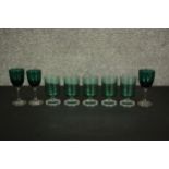 A collection of eight turquoise green glasses, including a set of five vintage clear stemmed goblets