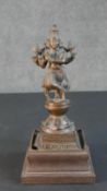 A 19th century bronze figure of an Indian deity on a shaped hardwood base. H.29 W.11 D.11cm (