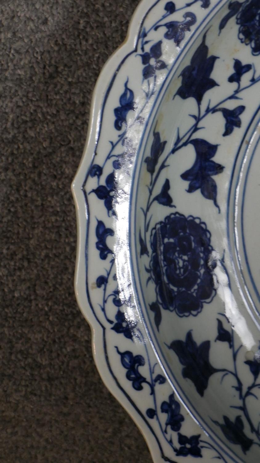 A large 19th century Chinese blue and white porcelain charger, painted with a central fish and - Image 4 of 6