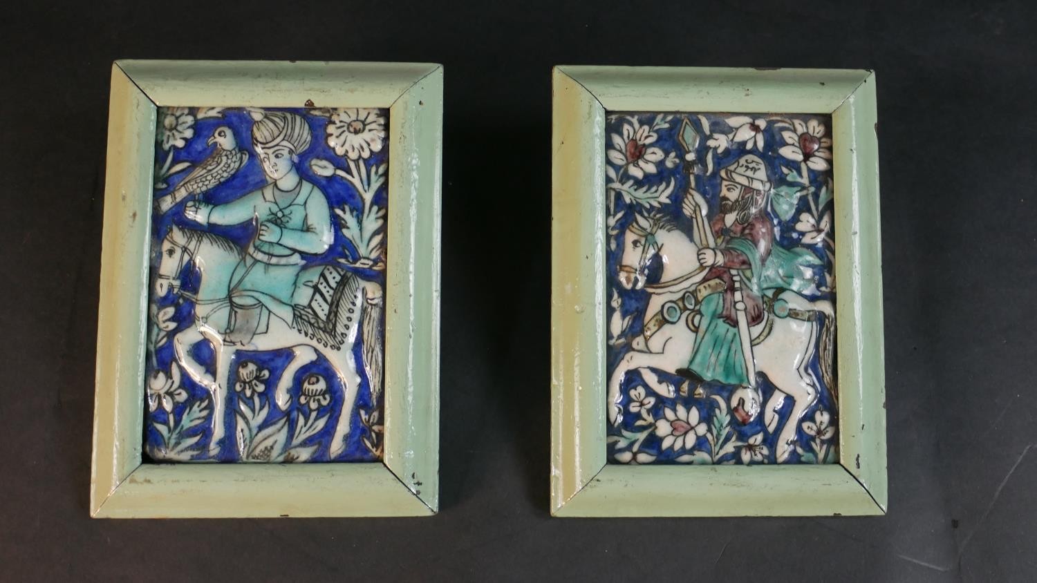 A pair of framed antique Qajar Persian hand painted and polychrome glazed ceramic tiles of