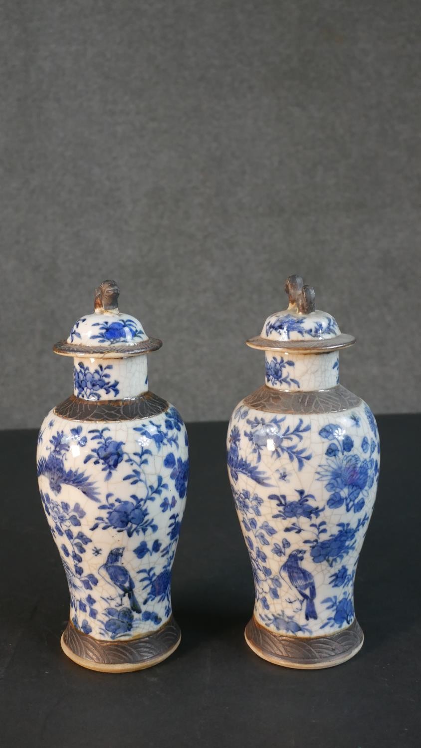 A pair of early 20th century Chinese blue and white crackle glazed vases and covers. The lidded jars - Image 6 of 8
