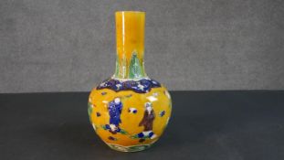 A 19th century Chinese Sancai yellow ground ceramic vase with figural design. Six character mark