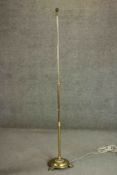 A Victorian brass floor lamp on a tripod foliate design stand. H.187cm