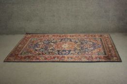 A blue ground fine handmade Persian Keshan rug with a central medallion. L.225 W.130cm.