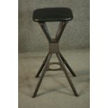 An early to mid 20th century steel industrial stool, with Mulberry leather seat, raised on four