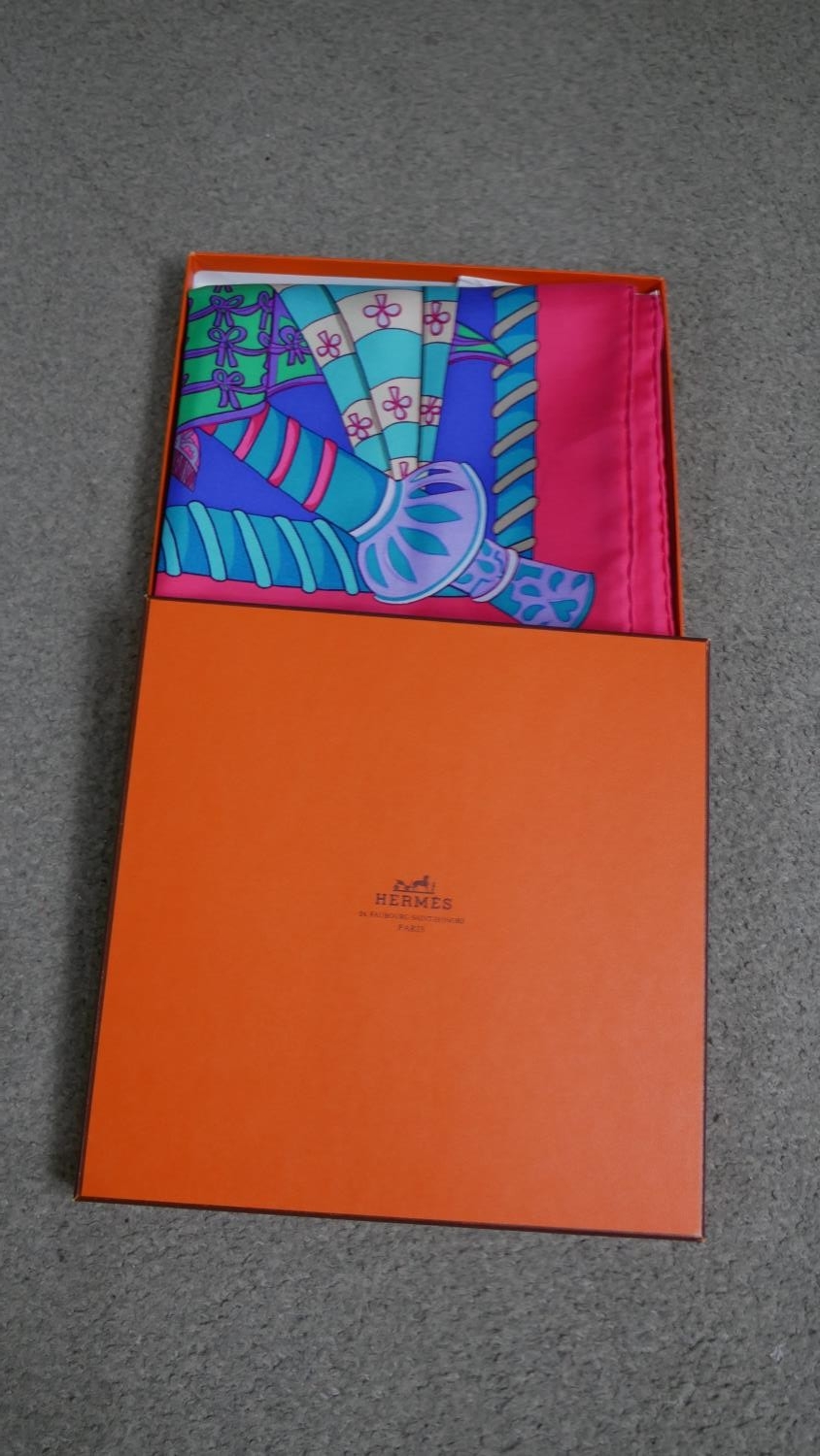 A Boxed Hermès silk scarf, pink, purple and teal 'Etendards et Bannieres', designed by Annie Faivre.