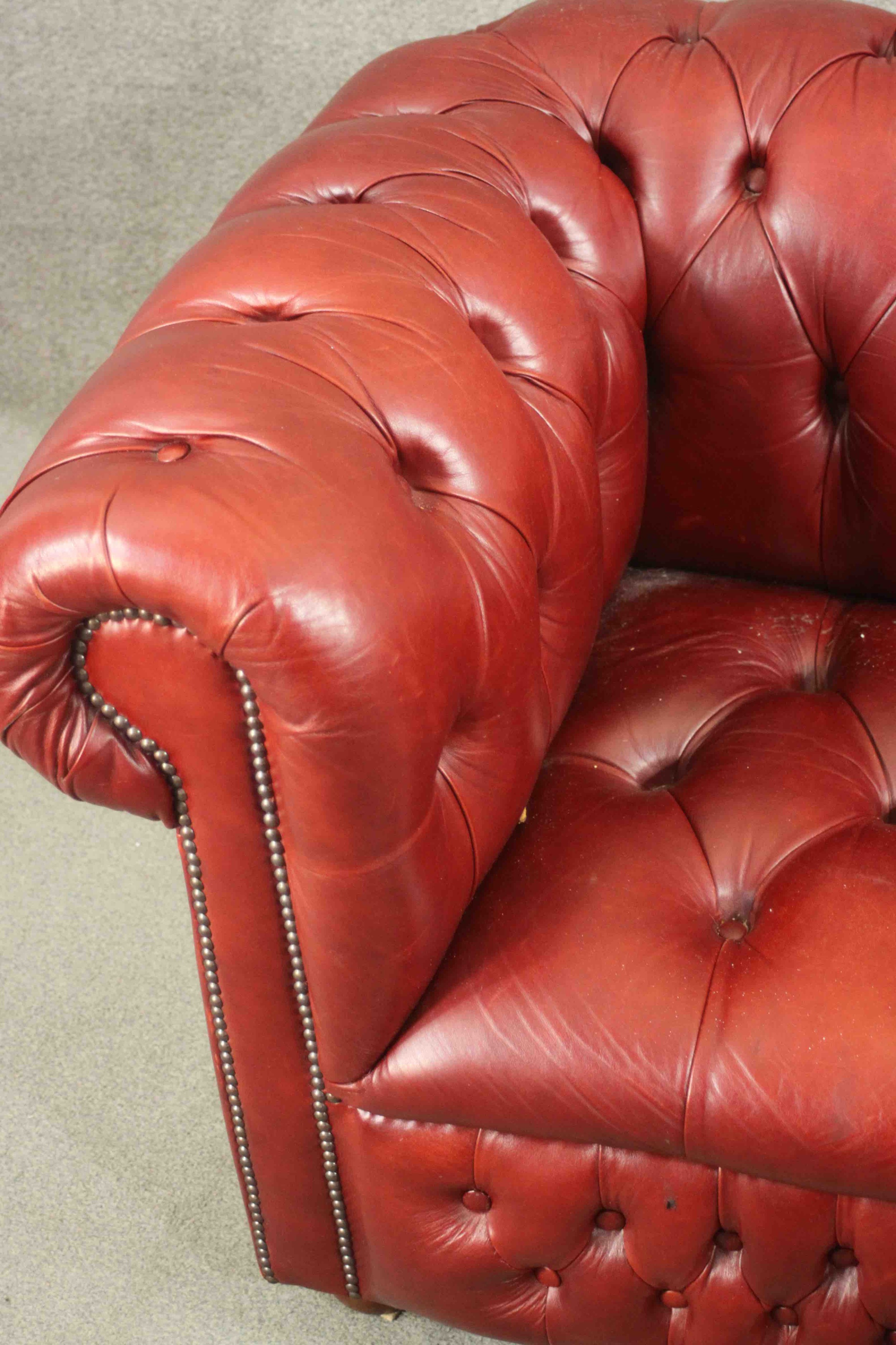 A red leather Chesterfield sofa, buttoned to the back, arms, seat, and front, on bun feet. H.75 W. - Image 5 of 8