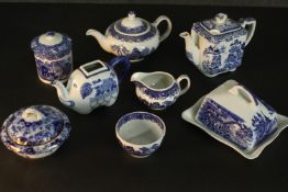A collection of eight pieces of blue and white transferware pottery, including lidded pots, butter