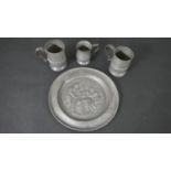A collection of pewter, including a 19th century repousse tavern scene platter with stamp to base