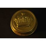 An early 20th century brass embossed box containing an Irish clerical wax seal. H.2.5 Dia.8cm.