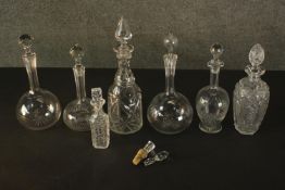 A collection of six cut crystal decanters and a perfume bottle with stopper. H.36 Dia. 10cm. (