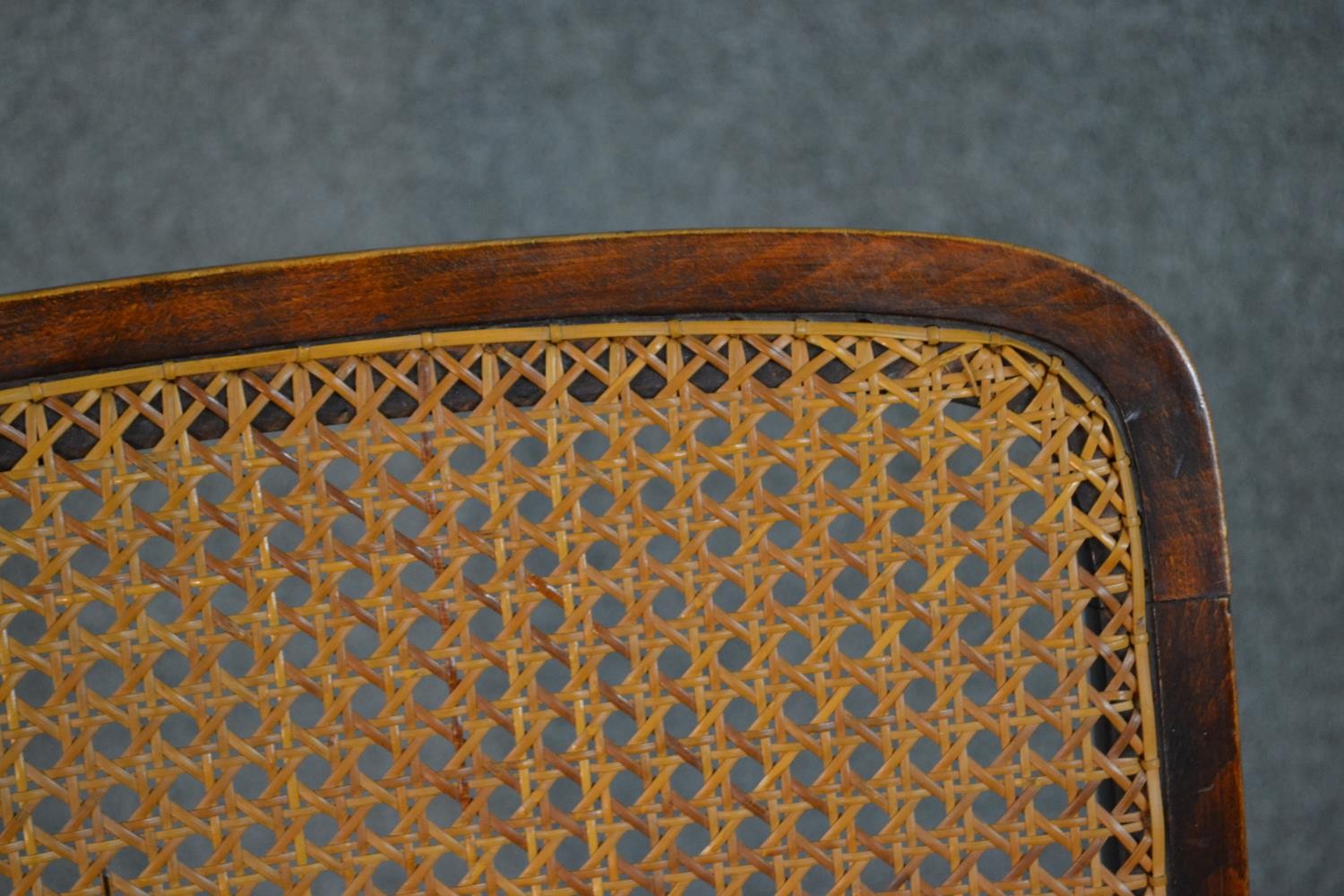 A circa 1900 stained beech rocking chair, with a caned back and seat, open arms, with bobbin - Image 5 of 5