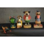 A collection of five carved and painted cartoon animals including, Donald Duck and a pig. H.34 W.