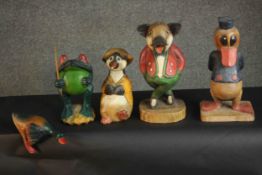 A collection of five carved and painted cartoon animals including, Donald Duck and a pig. H.34 W.