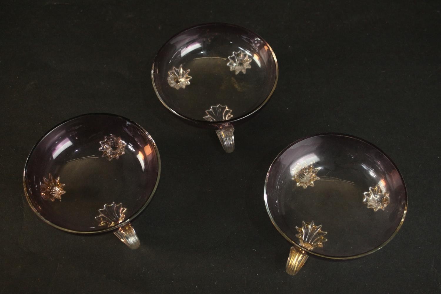 Three Murano style purple glass handled dishes. H.4 Dia.10cm.