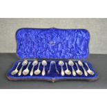 A set of twelve Victorian silver shell design tea spoons and sugar tongs in a fitted leather case.