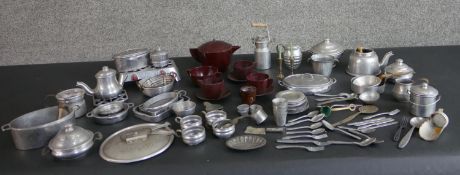 A large collection of early 20th century pewter dolls kitchen ware and an Art Deco marbled maroon